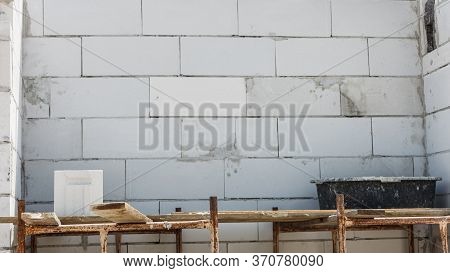 Details Of House Home Construction Site. Provisional Walls Made Of Grey Blocks.