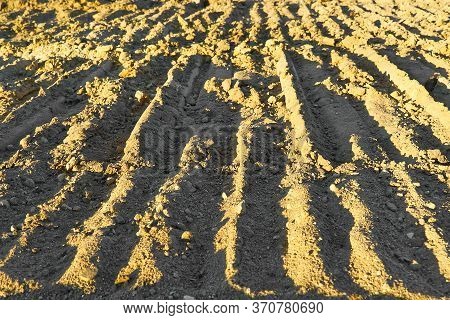 Excavator Tracks On The Ground Texture. Mud Ground Earth Soil Trace Tracks Marks Markings Dry Surfac