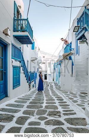Mykonos Greece, Couple Man And Woman On Vacation At The Greek Island Mykonos, Girl In Dress At The W