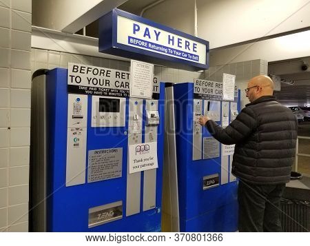 Philadelphia, Pennsylvania, U.s.a - December 8, 2019 - A Man Paying For Parking Tickets On The Elect
