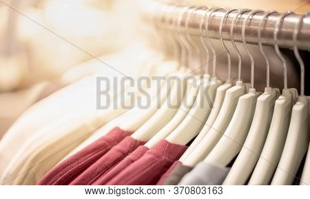 Modern Fashion Women Clothes Hang On Stanless Steel Hangers Rack At Clothing Store Department Store.