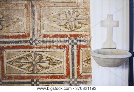 Hornachos, Spain - May 31st 2020: Fresco Painting Remains Beside Holy Water Font. Franciscan Convent