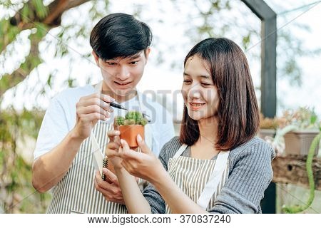 Women Hold Cactus And A Man Hands Point . Love Couple Enjoy Hobby With Darden Cactus.