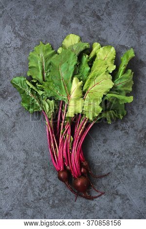 Group Of Chard With Beetroots. Young Beetroot With Fresh Leaves On Dark Background