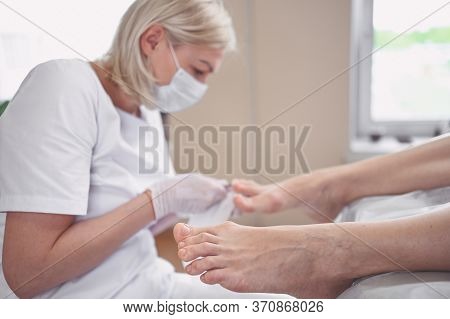 Pedicurist Doing Professional Medical Pedicure Procedure In Beauty Salon With Special Eguipment. Foo