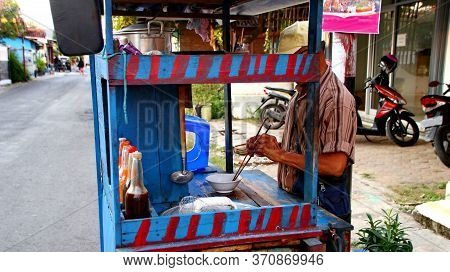 Indonesian Food, Mie Ayam, Noodles With Chicken Presented Directly By The Seller On The Cart, Unfocu