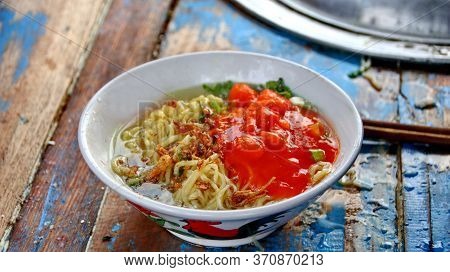 Indonesian Food, Mie Ayam, Noodles With Chicken Presented Directly By The Seller On The Cart, Unfocu