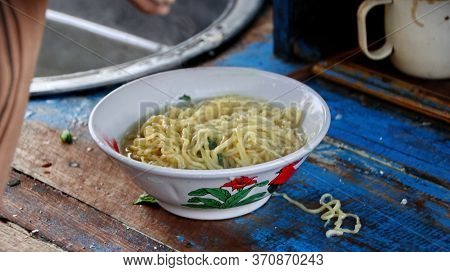 Indonesian Food, Mie Ayam, Noodles With Chicken Presented Directly By The Seller On The Cart, Unfocu