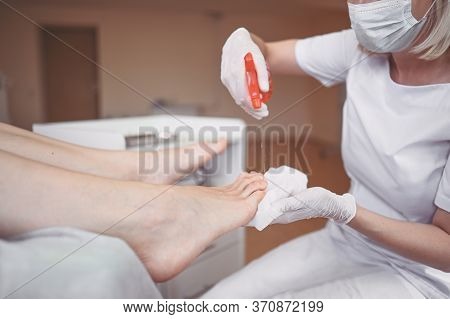 Pedicurist Doing Professional Medical Pedicure Procedure In Beauty Salon With Special Eguipment. Foo