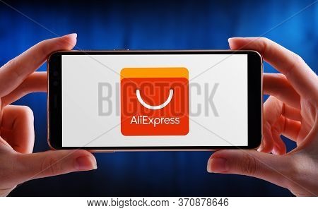 Hands Holding Smartphone Displaying Logo Of Aliexpress
