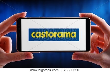 Poznan, Pol - May 21, 2020: Hands Holding Smartphone Displaying Logo Of Castorama, A French Retailer