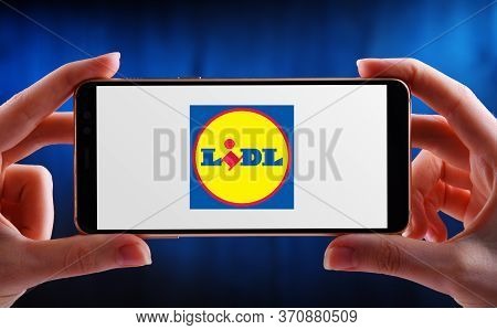Poznan, Pol - May 21, 2020: Hands Holding Smartphone Displaying Logo Of Lidl,  A Global Discount Sup