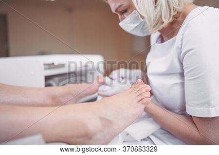 Pedicurist Doing Professional Medical Pedicure Procedure In Beauty Salon With Special Eguipment. Foo