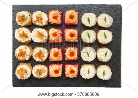 Set Of Fried Sushi Rolls With Fish And Rice On Black Stone Slate