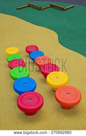 Childish Playground With Multi-colored Plastic Stumps For Climbing And Jumping Covered With A Rubber