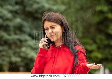 Beautiful Woman In Disbelief Spreads Her Arms From What She Heard From Her Boyfriend While Talking O
