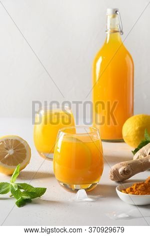 Jamu Indonesian Drink With Natural Ingredients Turmeric, Ginger, Lemon On White Background. Close Up