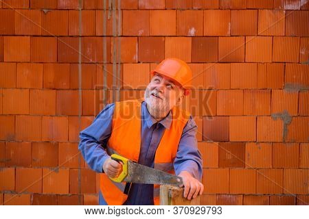 Construction Worker Sawing With Hand Saw. Handyman With Hand-saw. Carpentry Work. Builder Worker Car