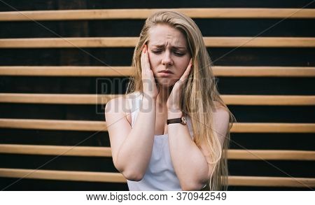 Young Caucasian Teenager With Blonde Hair Feeling Headache