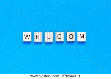 Welcome Sign In Wooden Letters On A Blue Background. Business Concept, Sales, Stores, Gifts. Top Vie
