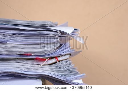 Stack Of Business Report Paper Files On Desk