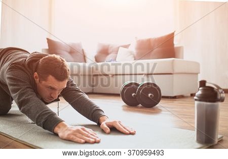 Young Ordinary Man Go In For Sport At Home. Cut View Of Beginner Guy Stretching His Body And Pull Ha