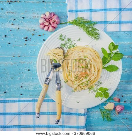 Beautifully-servered, Turquoise Wooden Table, On Which There Is A Plate With Italian Pasta With Chic
