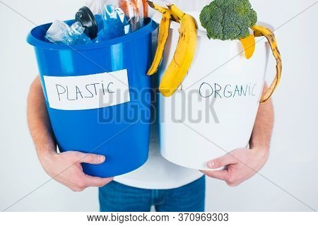 Young Man Isolated Over White Background. Cut View Of A Guy Holding Separated Buckets With Organic A