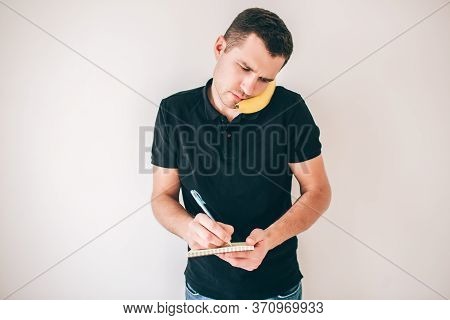 Young Man Isolated Over White Background. Guy Using Banana As Smartphone And Pretent To Talk On It. 