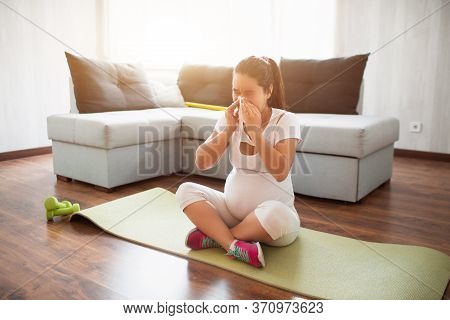 A Pregnant Woman Works Out On A Yoga Mat At Home. Pregnancy And Sports. Oga And Pilates For Pregnant