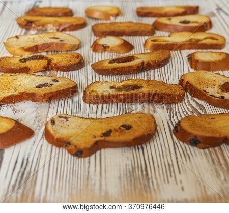Wheat Rusks On A Wooden Background. Background From Rusks. Photographed Close-up.