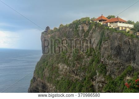 View Of Uluwatu Cliff With Pavilion And Blue Sea In Bali, Indonesia. Uluwatu Temple Pura Luhur Uluwa