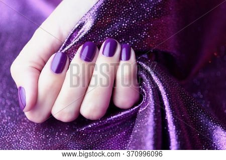 Purple Manicure On A Purple Shiny Background