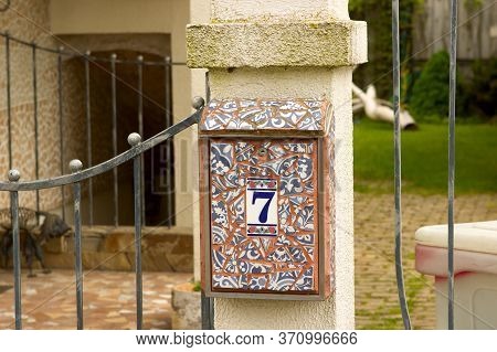 Exclusive Colorful Bright Unusual Mailbox Decorated With Shards Of Tiles. Mailbox At The Gate Of A P