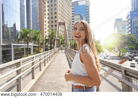 A Surprised Girl Looks Around In Sao Paulo Metropolis, Brazil
