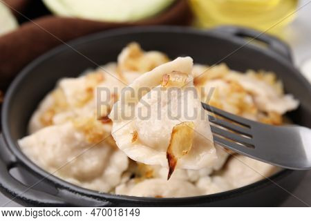 Fork With Delicious Dumpling (varenyk) And Fried Onions Over Plate, Closeup