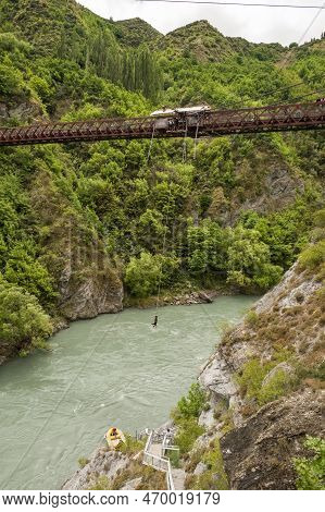 Kawarau Bridge, Queenstown, New Zealand - 20th December 2022: A Bungy Jumper Hangs Above The Kawarau
