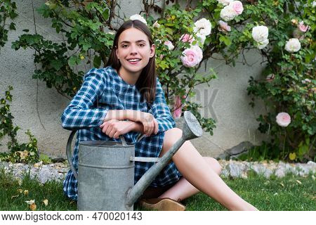 Beautiful Sexy Girl Near Rose Flower In Spring Garden. Young Woman In Flowering Garden With Roses. G