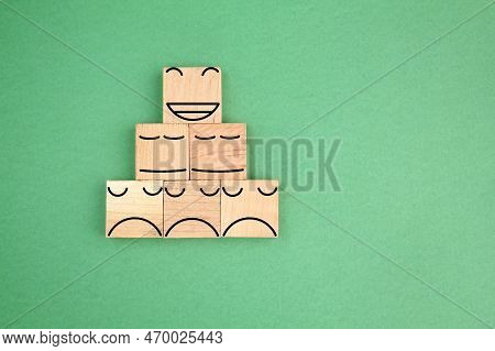 Wooden Cube With A Happy Face Icon On Top And A Sad Face On The Bottom. Emoticon Icons Face On Woode