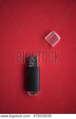 Usb Flash Drive Close-up On A Red Background. One Usb Flash Drive With A Lid.