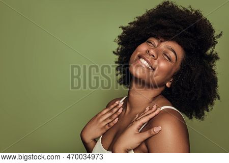 Side View Of Cheerful Young African American Female Millennial With Coily Hair And Perfect Skin Smil