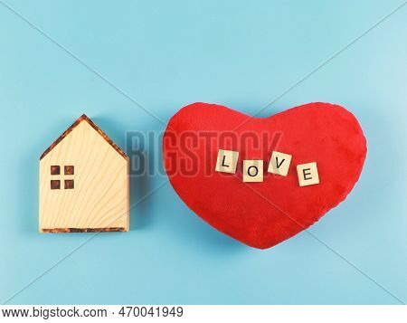 Top View Or Flat Layout Of Wooden Model House And Red Heart Shape Pillow With Wooden Letters L O V E