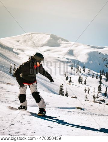 Close Up Snowboarder Snowboard Fast On Slope Downhill In Winter Ski Resort. Sports Wear, Fun In Gode