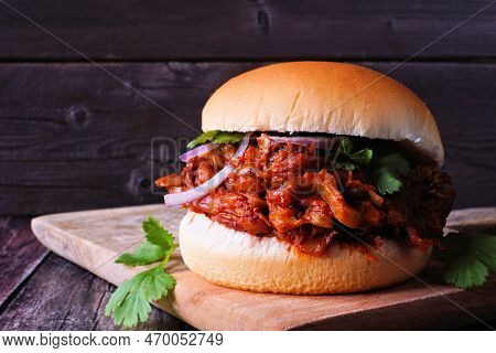 Jack Fruit Meatless Burger Against A Dark Wood Background. Healthy Eating, Plant-based Pulled Pork M
