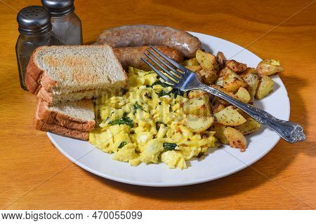 Scramble Eggs With Sp[inach Served With Italian Sausage  And Homefries