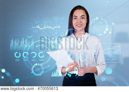 Smiling Attractive Businesswoman Wearing Formal Wear Standing Holding Pack Of Documents Near Digital