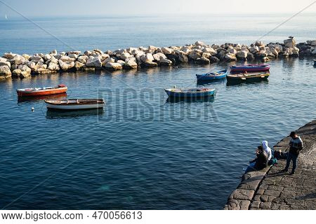 Naples, Italy - January 1, 2023: People Enjoy The Sea View Around The Seafront Of Naples