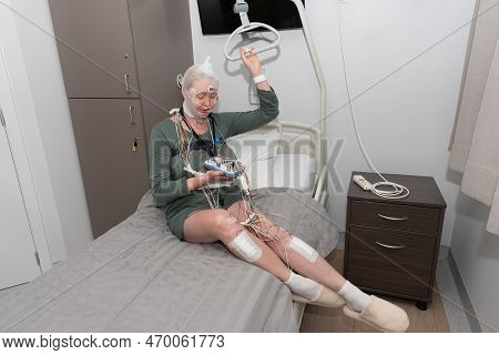 Middle Aged Woman Measuring Brain Waves, Examining Polysomnography In Sleep Lab