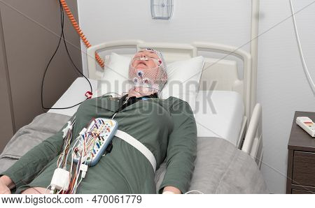 Middle Aged Woman Measuring Brain Waves, Examining Polysomnography In Sleep Lab