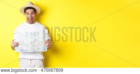 Travelling, Vacation And Tourism Concept. Man Tourist Looking Happy At Map With Sighsteeings, Explor